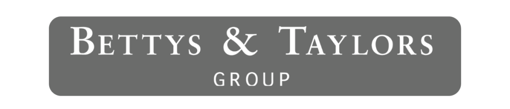 A dark grey box with white text saying "Betty & Taylors Group"
