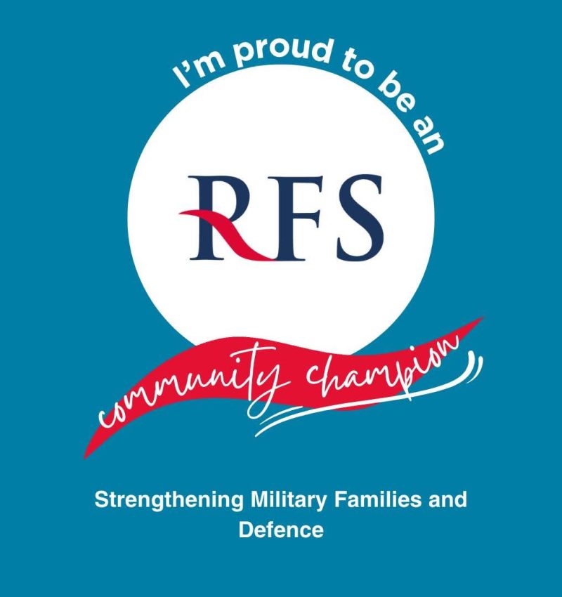 A teal graphic with a white circle in the centre showing the RFS logo. Curved white text reads “I’m proud to be an RFS community champion,” with a red ribbon-style banner across the middle. Text at the bottom reads “Strengthening Military Families and Defence.”