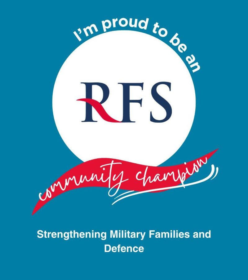 A teal graphic with a white circle in the centre showing the RFS logo. Curved white text reads “I’m proud to be an RFS community champion,” with a red ribbon-style banner across the middle. Text at the bottom reads “Strengthening Military Families and Defence.”